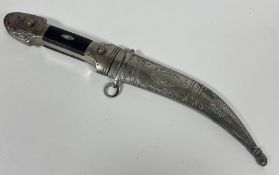A Eastern white metal plated curved dagger with steel blade and wood mounted handle, (L x 26cm)
