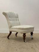 A Victorian bedroom chair, the back and seat upholstered in buttoned ivory cotton, raised on