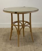 A Lloyd loom bistro or breakfast table, the circular basketwork top with plate glass cover and brass