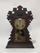 An American stained hardwood mantel clock by E.N. Welch, late 19th century, full glazed door with