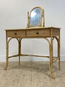A Vintage bamboo and rattan dressing table, with swing mirror and plate glass top over two drawer,
