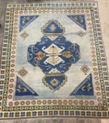 A Turkish Hand knotted carpet, the pale blue abrashed field with geometric decoration within a