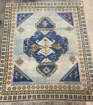 A Turkish Hand knotted carpet, the pale blue abrashed field with geometric decoration within a