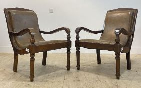 A pair of Victorian style walnut framed steamer type chairs, with tan leather upholstered seat and