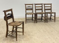 A set of four late 19thc century beech framed chapel chairs, with stencilled numbers to crest