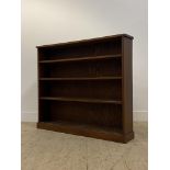 An early 20th century mahogany open bookcase, fitted with three fixed shelves on a skirted base.