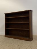 An early 20th century mahogany open bookcase, fitted with three fixed shelves on a skirted base.