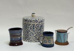 A group comprising a blue and white with all over scrolling leaf design ceramic canister (h-25cm w-