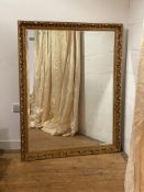 A large acanthus moulded gilt composition framed wall mirror with bevelled plate 132cm x 103cm