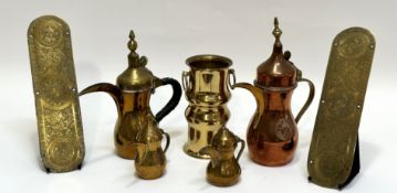 A collection of brass wares comprising two finger plates (l-29.5cm), four middle eastern teapots,