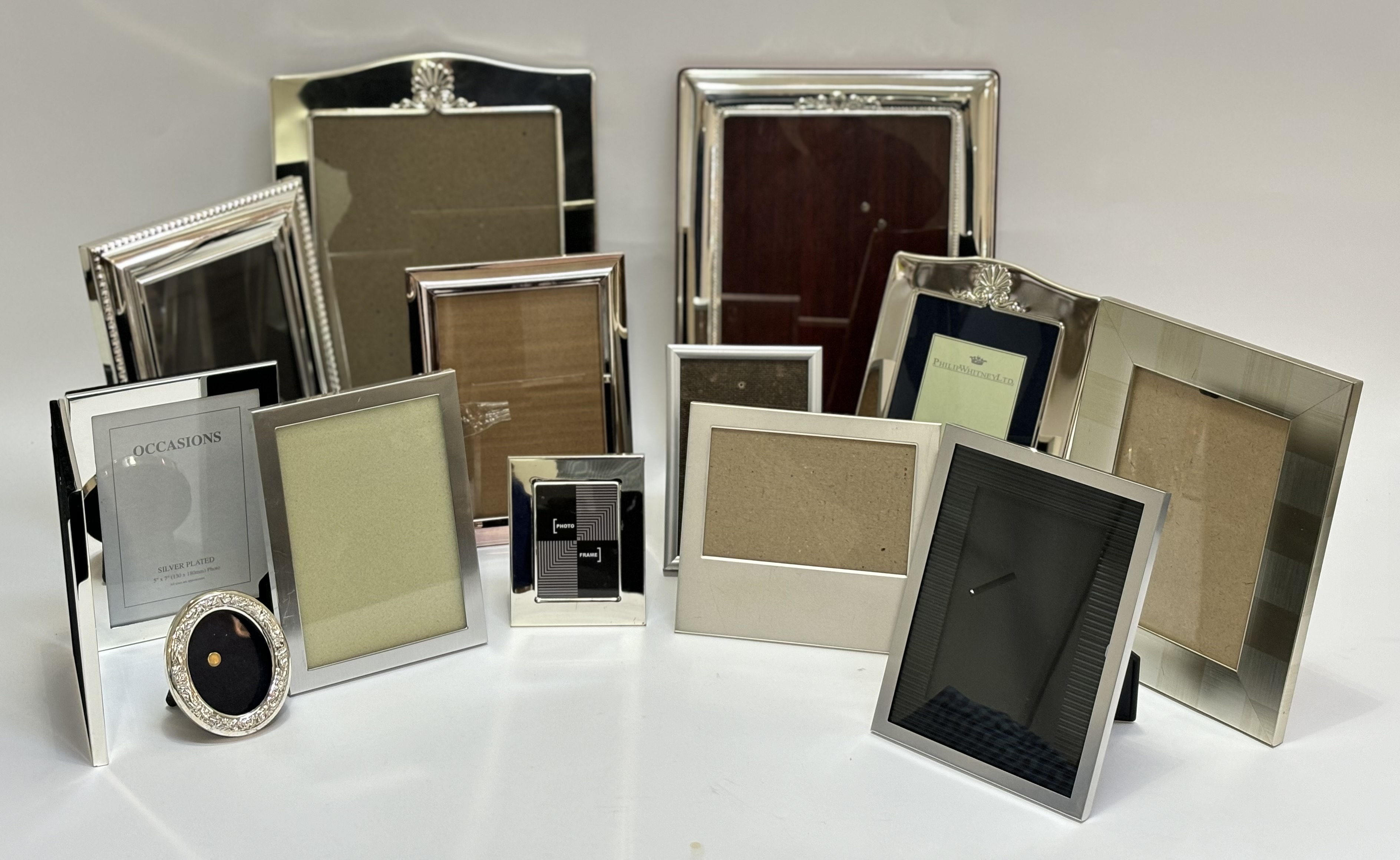 A collection of photo frames comprising a graduated set of three silver plated frames, three various