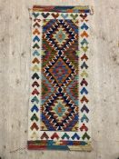 A Chobi kilim runner rug of typical design 147cm x 60cm