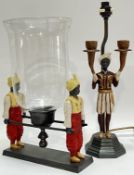 An Orientalist style candle holder with glass shade/guard, modelled with two figures in Arabic dress