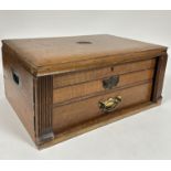 A Edwardian oak canteen fitted lift up top and two fitted drawers containing a part suite of old