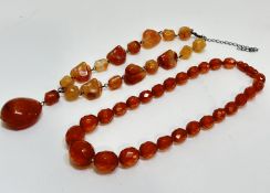 A vintage honey coloured faceted graduated amber bead necklace, (L x 20cm) 37.84g and a amber