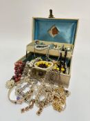 A Jewellery box containing a large collection of bead and paste necklaces, white metal bracelets,