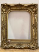 An ornate 19th century Baroque style gilt composition picture frame 77cm x 93cm