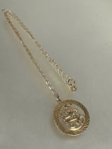 A 9ct gold circular pendant of an archer, (D x 2cm) on 9ct gold chain necklace, (L x 23cm) 4.4g