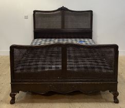 Heal's of London, an Edwardian carved mahogany and double bergere king size bed, the crest rail well