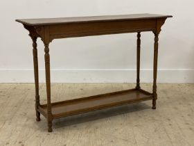 A late Victorian oak console table, the rectangular top raised on turned supports united by an under