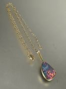 18ct gold mounted pendant set shaped black opal in rub-over setting, (L x 2.5cm x W x 1.5cm) with