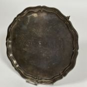 A Sheffield silver scalloped salver with fluted edge raised in three scroll feet, (H x 3cm x D x