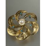 A 1960's gold circular textured scrolling leaf shaped brooch set central cultured pearl and six