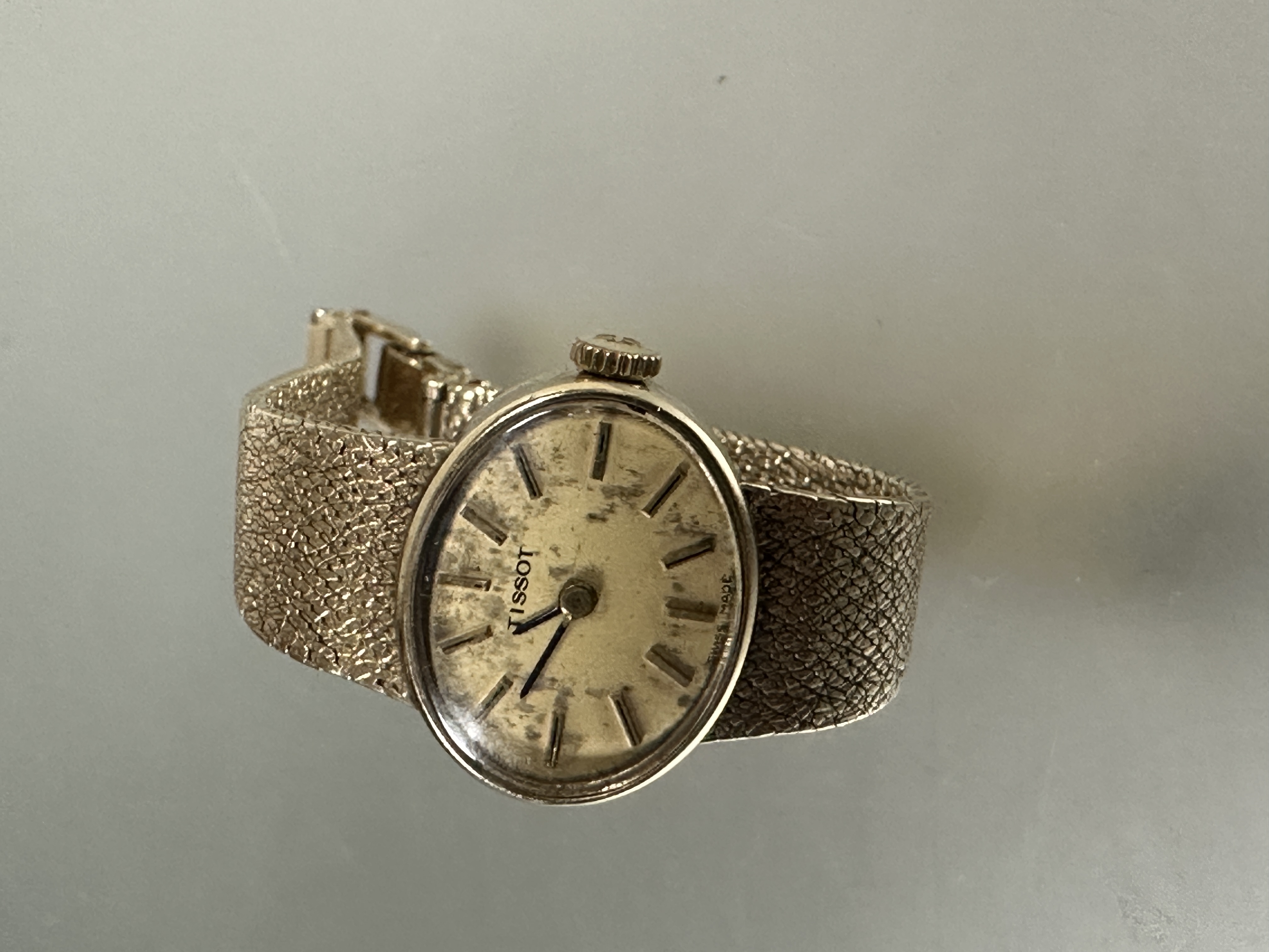 A Lady's yellow metal 1960's Tissot manual wind wristwatch with oval gilt dial and baton hour