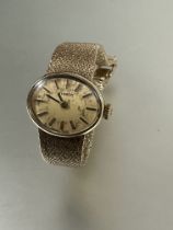 A Lady's yellow metal 1960's Tissot manual wind wristwatch with oval gilt dial and baton hour