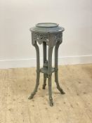An early 20th century green painted jardiniere stand, the turned top over floral carved frieze and