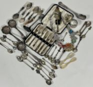 A collection of Continental white metal and sterling silver souvenir tea spoons, two Epns napkin