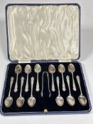 A Sheffield silver set of twelve engraved with initial B tea spoons and pair of matching tongs in