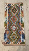 A hand knotted  chobi kilim runner rug of all over geometric design 150cm x 69cm