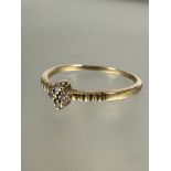 A 1920's European 10ct gold ring set four diamond points in claw setting flanked by engraved