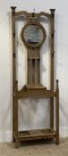 An Arts and Crafts period oak hall stand, the raised back with seven cast metal hooks and centred by