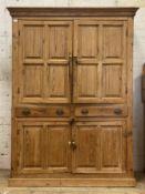 A George III pitch pine estate cupboard, the projecting cornice above two fielded panelled doors