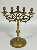 A Eastern cast brass five branch candle stick with dear cast branch supports on turned column and