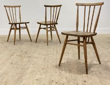 Ercol, a set of three beech and elm comb back dining chairs, mid 20th century. H60cm