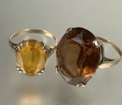 A 9ct gold oval cut citrine solitaire ring, L (L x 1.3cm X W 1cm) and a yellow metal set oval