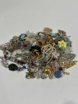 A collection of Vintage costume jewellery, including paste set brooches, hat pin, enamel fish