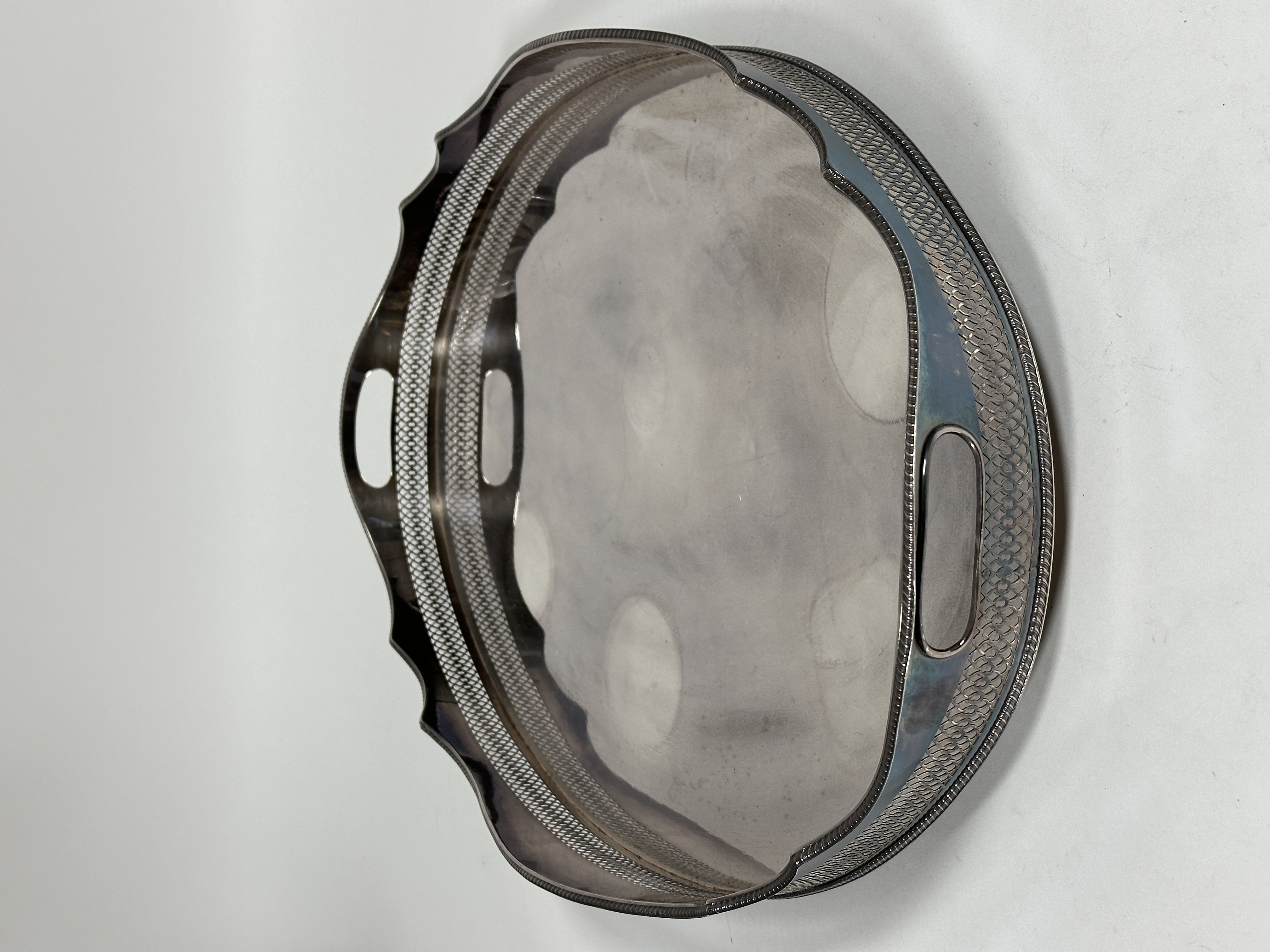 A large Sheffield plated scalloped oval pierced gallery two handled drinks tray raised on bun - Image 2 of 3