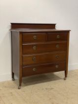 An Edwardian mahogany chest, the ledge back over two short and three long drawers raised on square