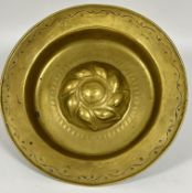 A 18th- 19thc Alms dish of circular embossed design with central leaf scrolling panel and beaded