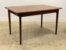 A Younger Ltd, a mid century teak extending dining table, the shaped top raised on tapered