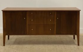 A Younger Ltd, a mid century teak sideboard, the shaped top over three centre drawers flanked by