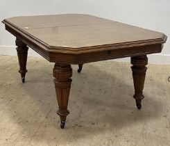 A Victorian oak wind out extending dining table, the top with moulded edge and canted corners having