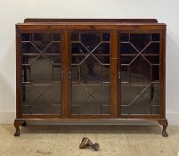 An early 20th century mahogany bookcase, fitted with three with astragal glazed doors, each