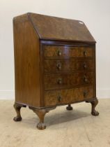 A 1930's burr walnut bureau, the fall front opening to a fitted interior, above four bow front