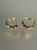 A pair of 18ct gold graduated hoop earrings set oval faceted amethysts, (D x 1.8cm) 3.3g