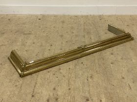 An Art Nouveau period hammered and cast brass fire curb L140cm